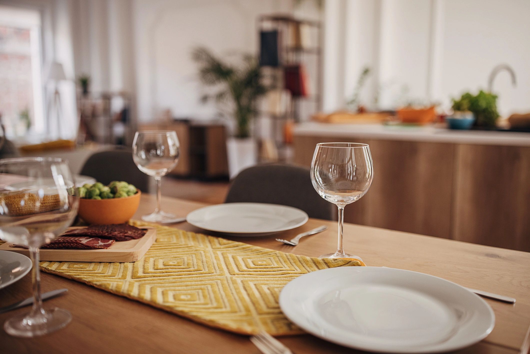 Wine glasses and table setting ready for dinner